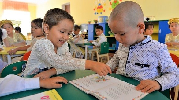 Болалар МТМда китоб мутолаа қилмоқда, Маллабой қишлоғи, Ўзбекистон. Боланинг илк олти йили унинг жисмоний, ақлий, лингвистик ва ижтимоий-руҳий ривожланишида муҳим давр ҳисобланади. Боланинг ушбу даврда бошидан кечирганлари унинг келажагини шакллантириб, белгилаб беради, дейди мутахассислар. (Мирзобек Ибрагимов/Жаҳон Банки)