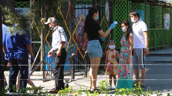 Девушка меряет температуру у посетителей городского парка. Тараз, 1 июня. [Айдар Ашимов]